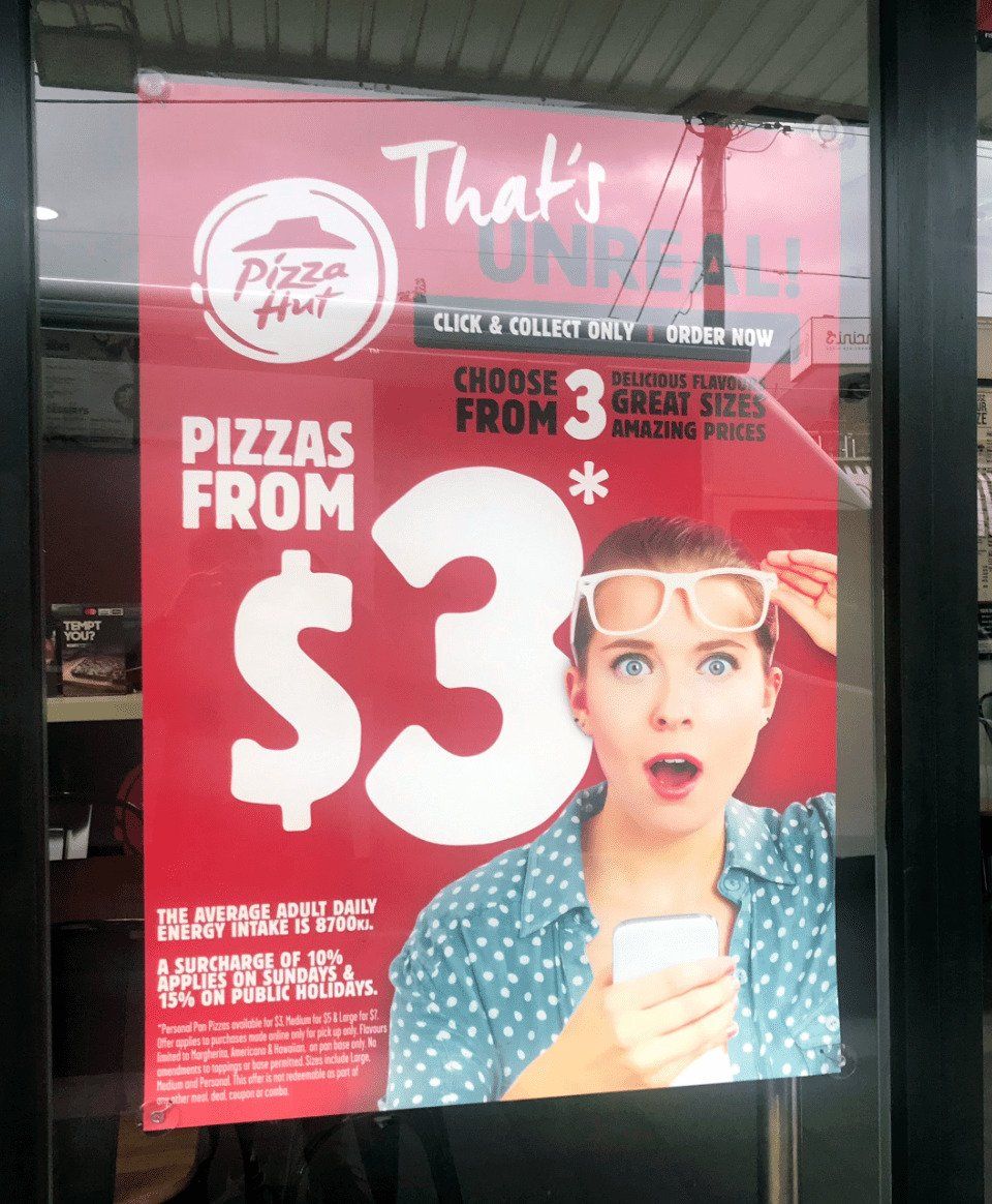 That's unreal Pizza Hut ad poster in store window