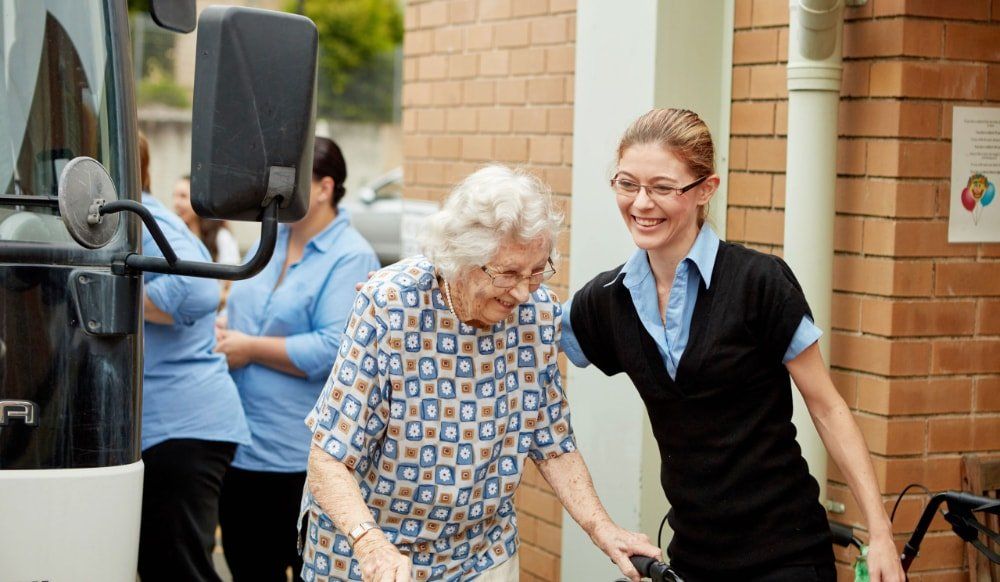 Someone assisting an older person to walk