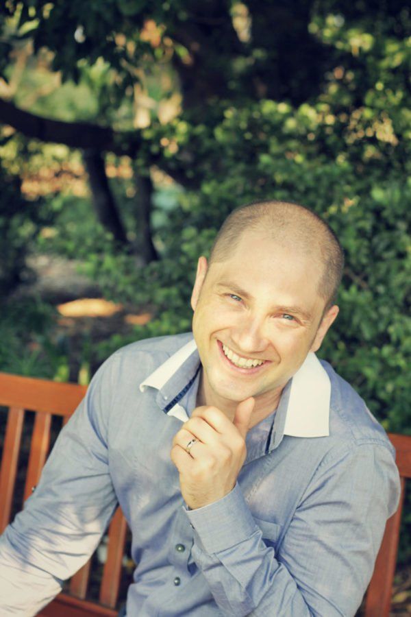 Ashton Bishop sitting on a bench smiling