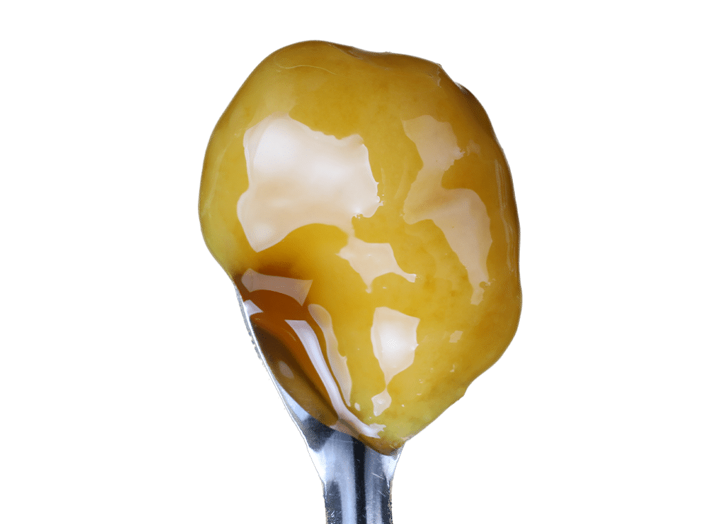 Purple cannabis bud with orange hairs and white trichomes.