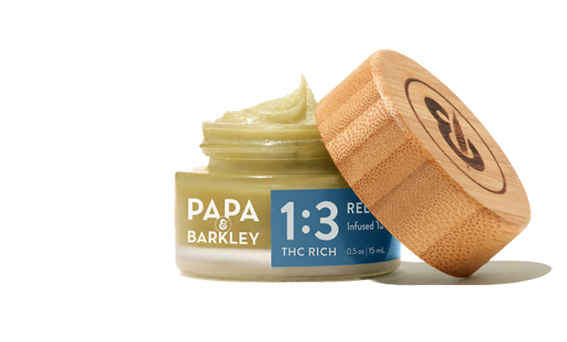 Purple cannabis bud with orange hairs and white trichomes.