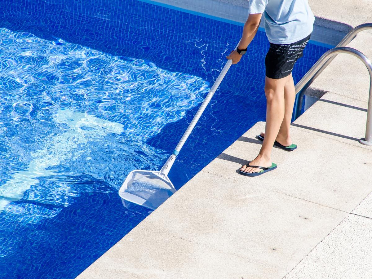 Man Cleaning Pool — Pittstown, NJ — Advantage Pools