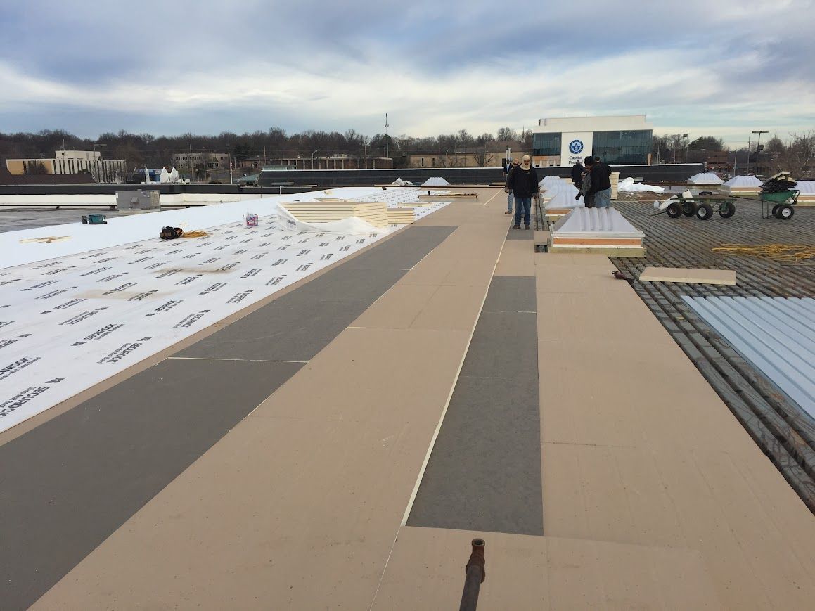 Open-air metal structure with multiple horizontal bars and rectangular ceiling, viewed from a low angle.