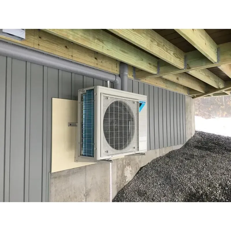 An air conditioner is mounted to the side of a building.