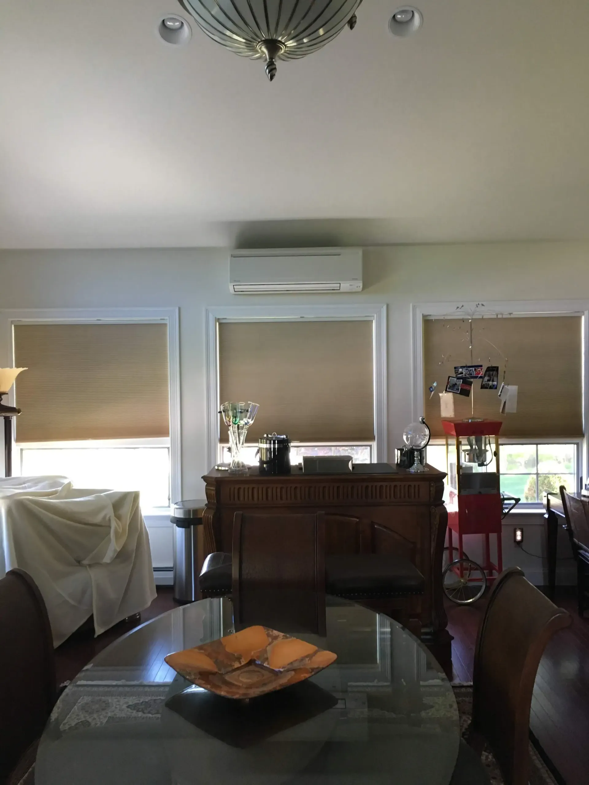 A living room with a table and chairs and a bowl on the table
