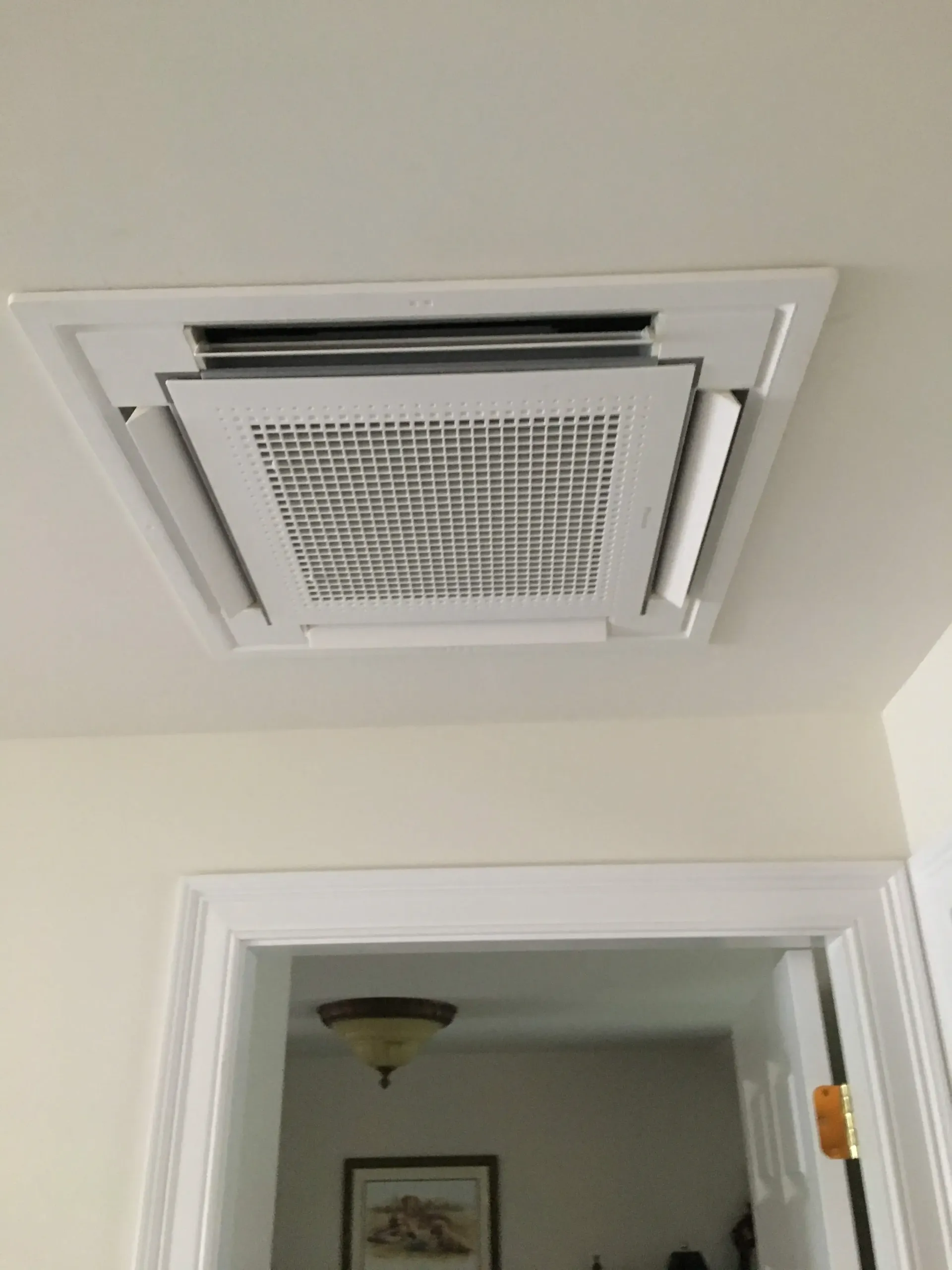 A ceiling fan is hanging from the ceiling of a room next to a door.