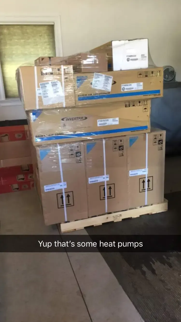 A bunch of boxes are stacked on top of each other on a wooden pallet.