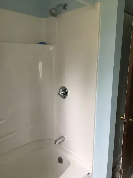 A bathroom with a bathtub and a shower.