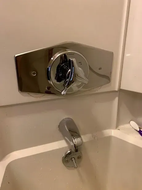 A close up of a bathtub faucet in a bathroom.