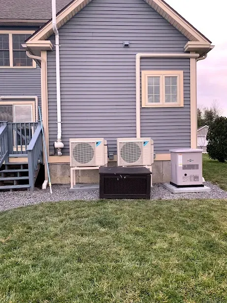 A house with a lot of air conditioners on the side of it.