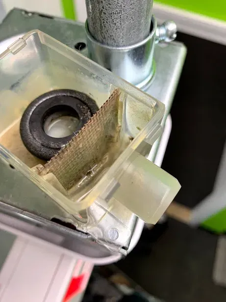 A close up of a plastic container with a metal ring in it.