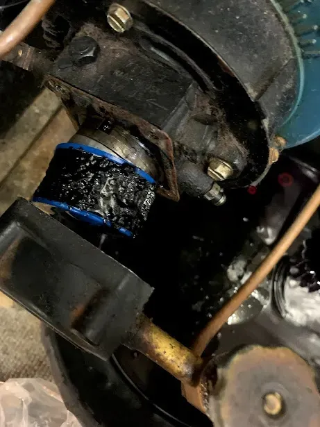 A close up of a machine with a lot of oil on it.