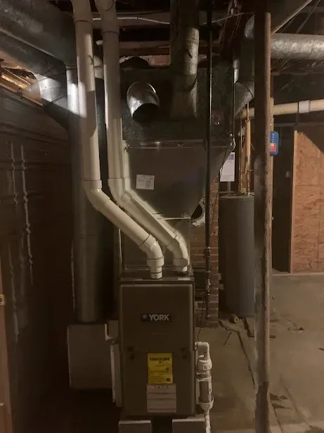 A picture of a furnace in a basement.