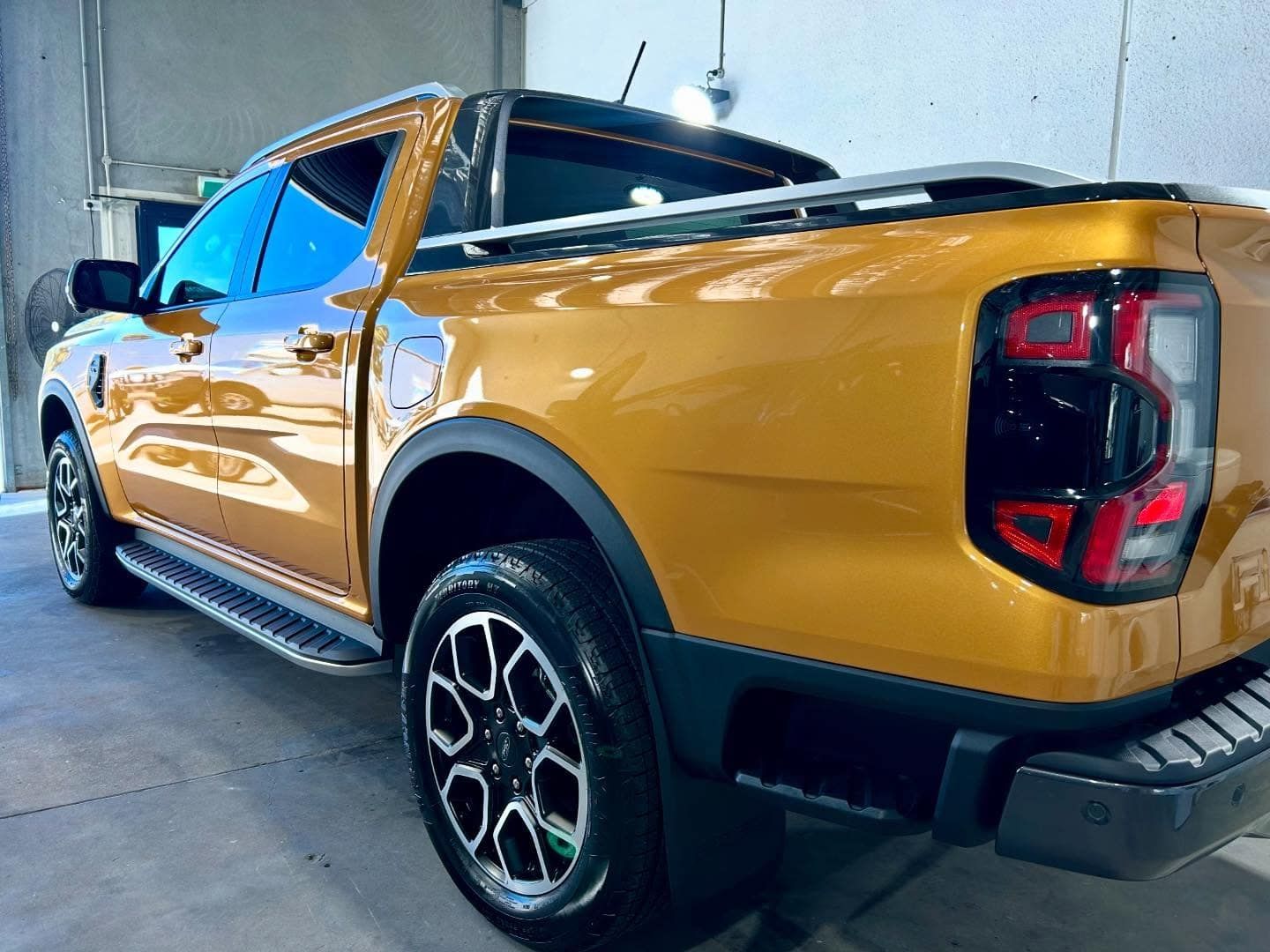 A Yellow Pickup Truck Is Parked In A Garage — Fraser Coast Automotive Coatings in Dundowran, QLD