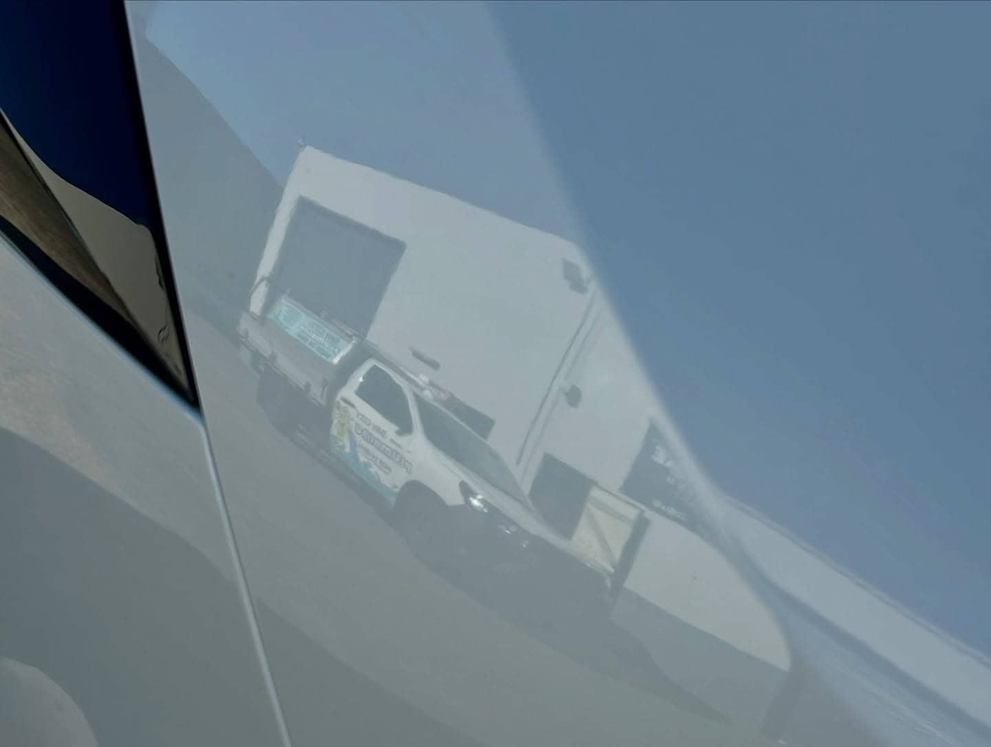 A Close Up Of A Car Door With A Reflection Of A Building In It — Fraser Coast Automotive Coatings in Dundowran, QLD