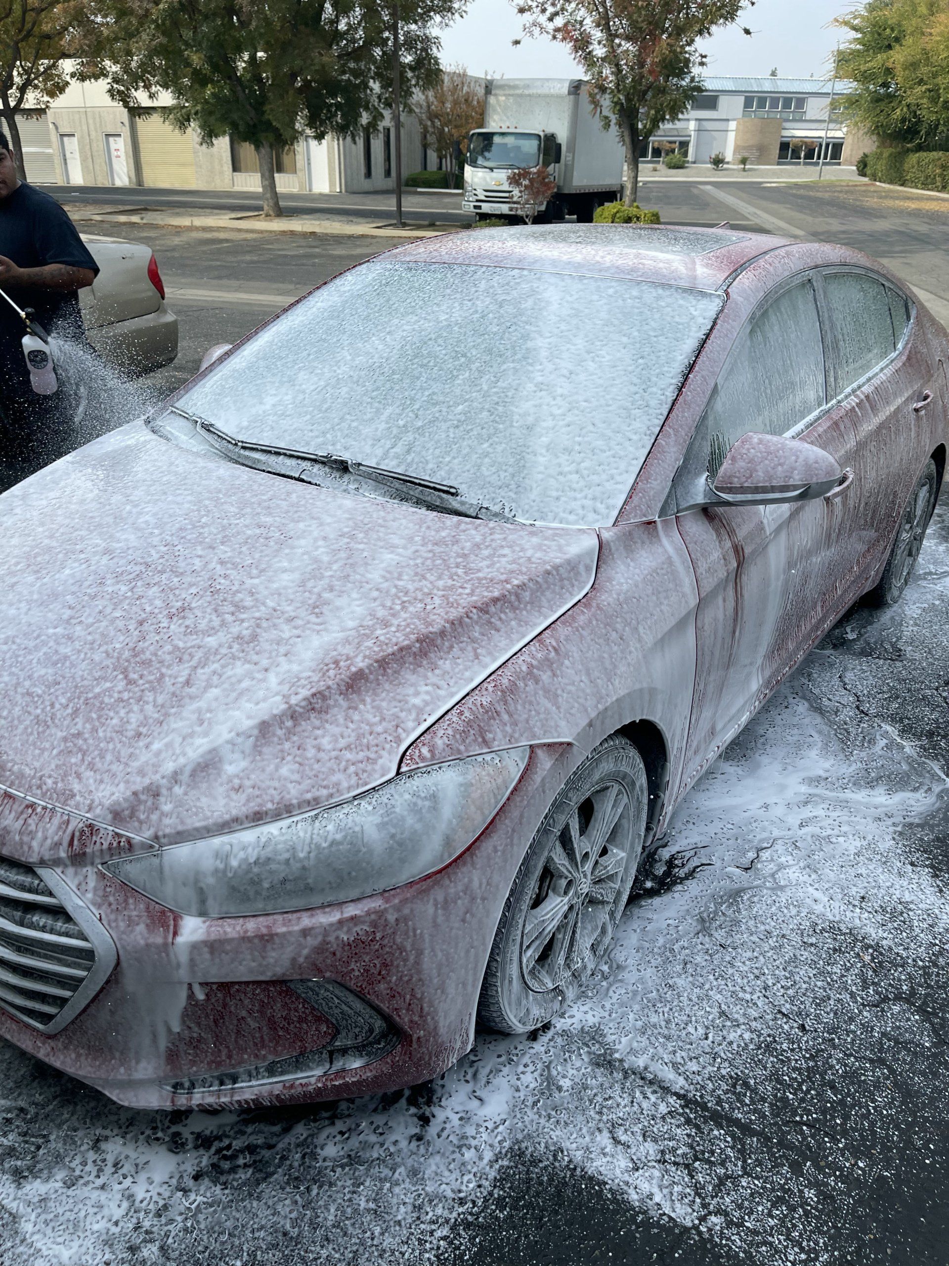 Fresno Auto Detailing - Red Car Being Cleaned