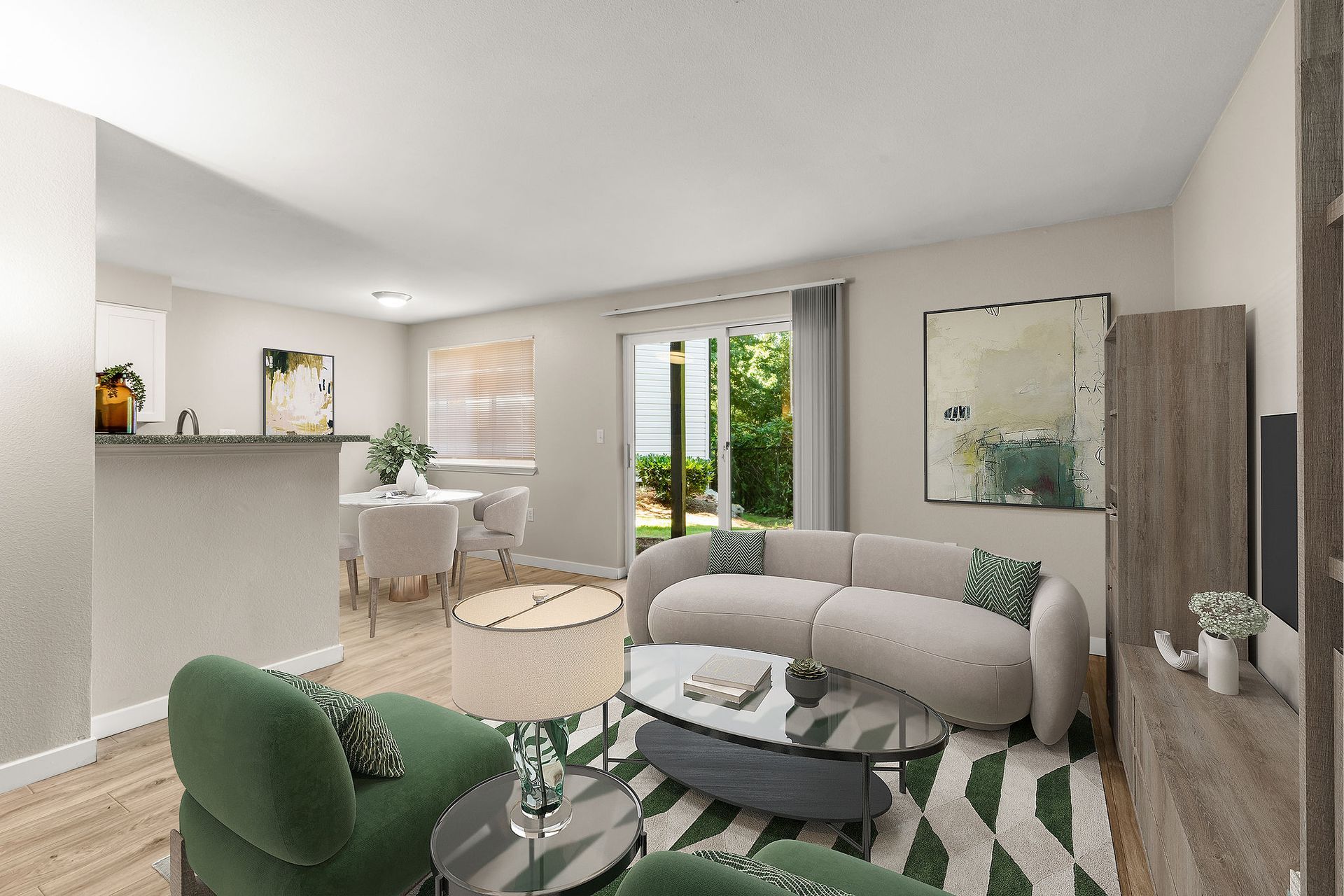 Cozy living room with curved sofa, green armchair, round coffee table, and dining area.