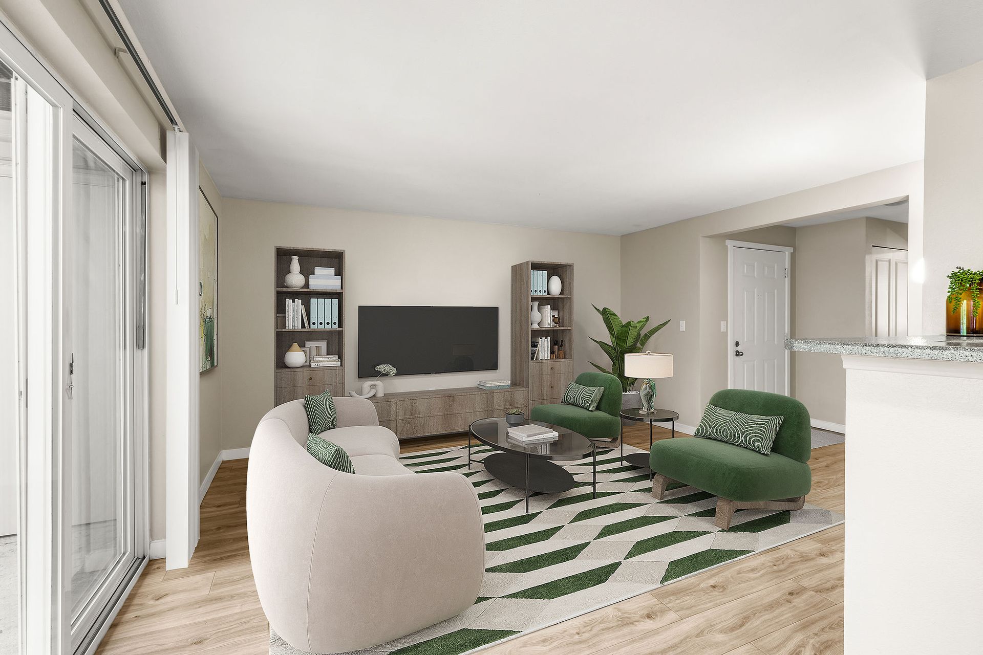 Living room with white sofa, green chairs, patterned rug, and TV.