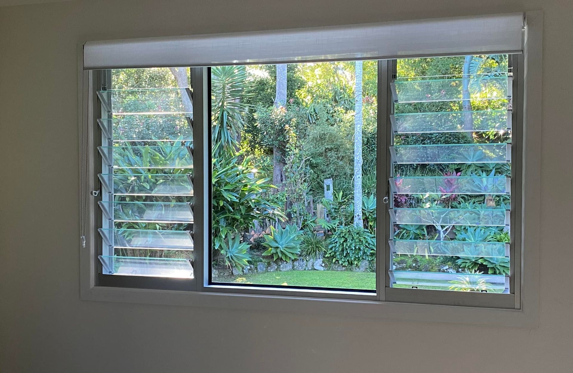 A Bedroom With A Large Window Looking Out To A Garden. — Eastcoast Aluminium & Glass In Ballina, NSW