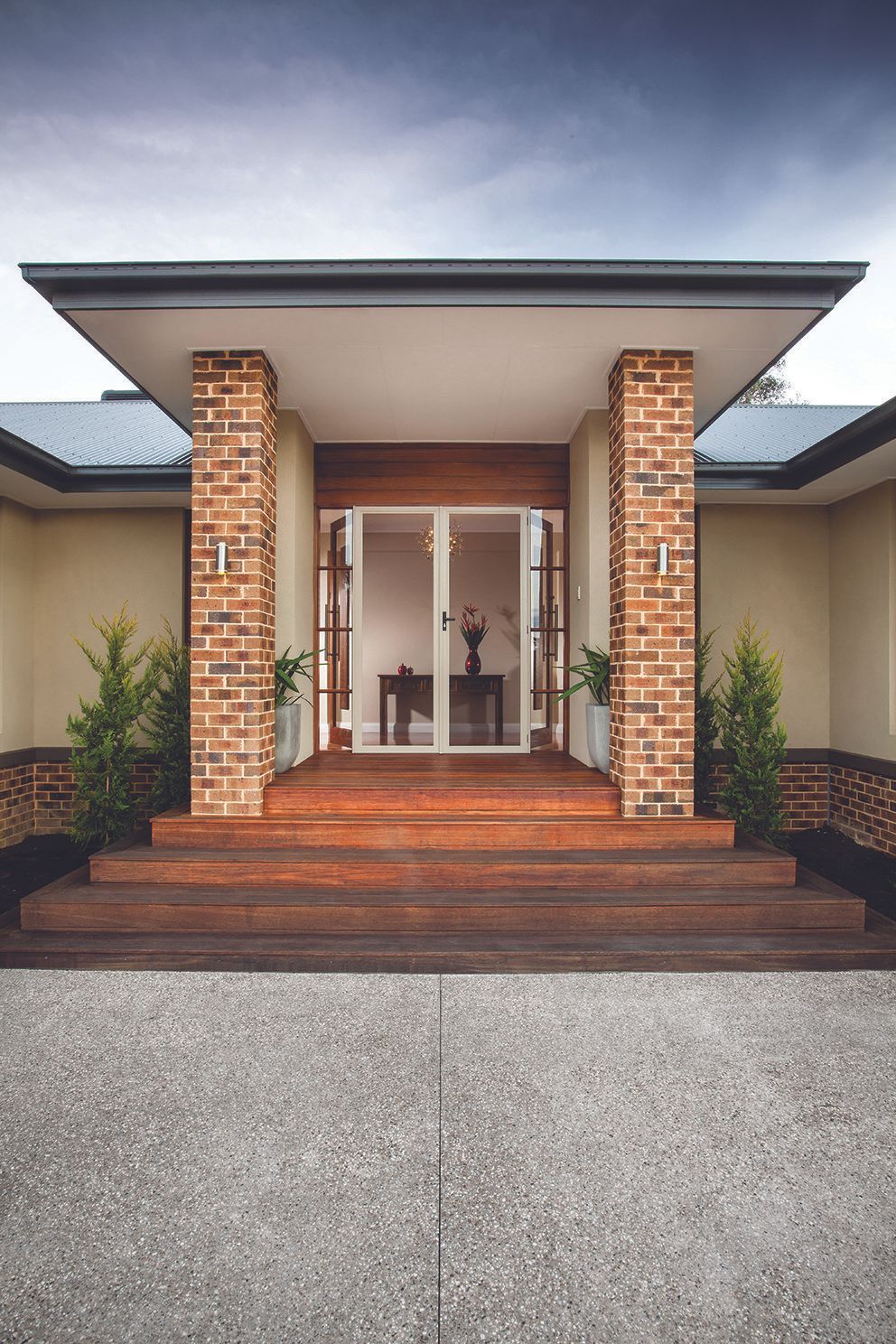 The Front Door Of A House With A Brick Column And Sliding Glass Doors — Eastcoast Aluminium & Glass In Ballina, NSW