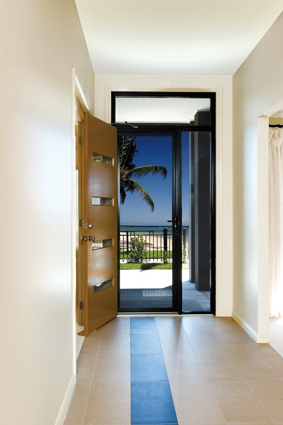 A Hallway With A Door Open And A View Of The Ocean — Eastcoast Aluminium & Glass In Ballina, NSW