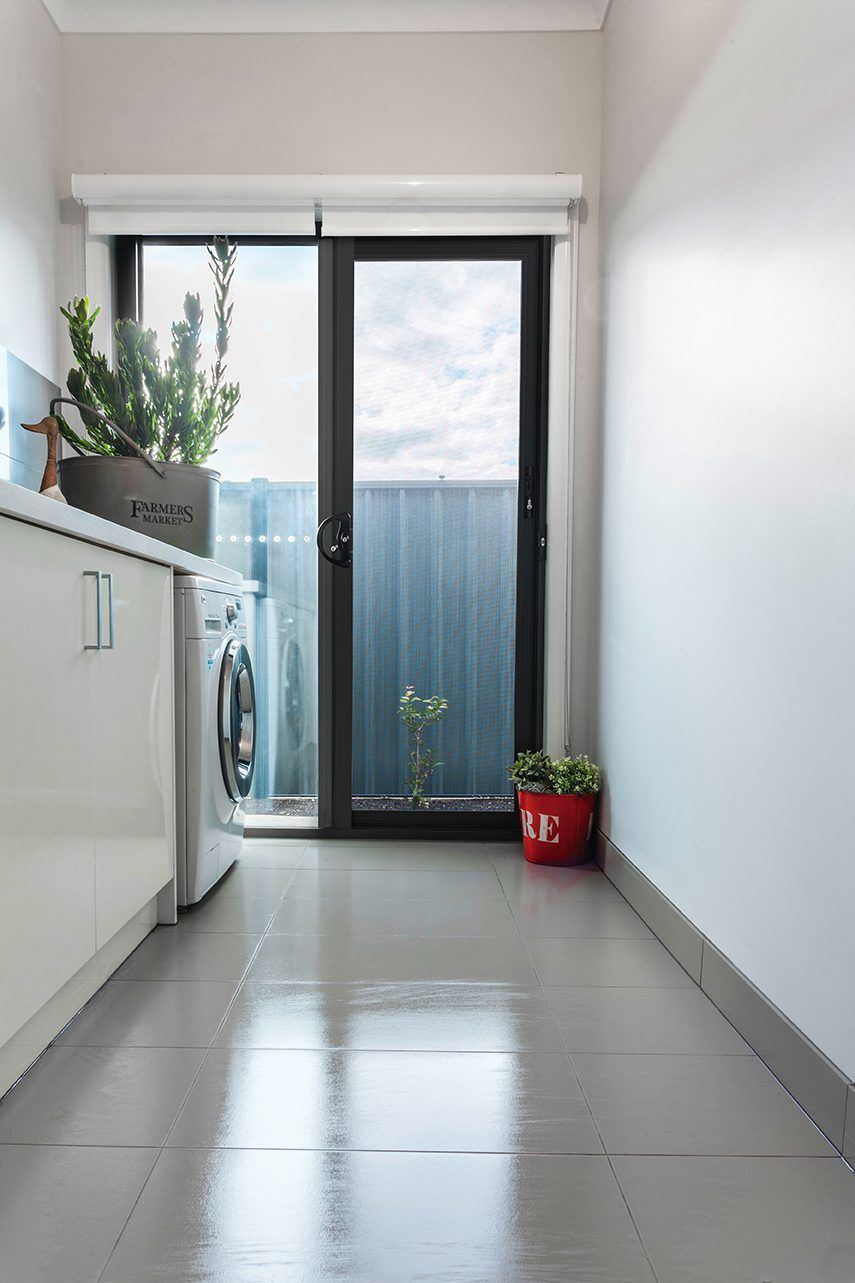 A Laundry Room With A Sliding Glass Door And A Washer And Dryer — Eastcoast Aluminium & Glass In Ballina, NSW