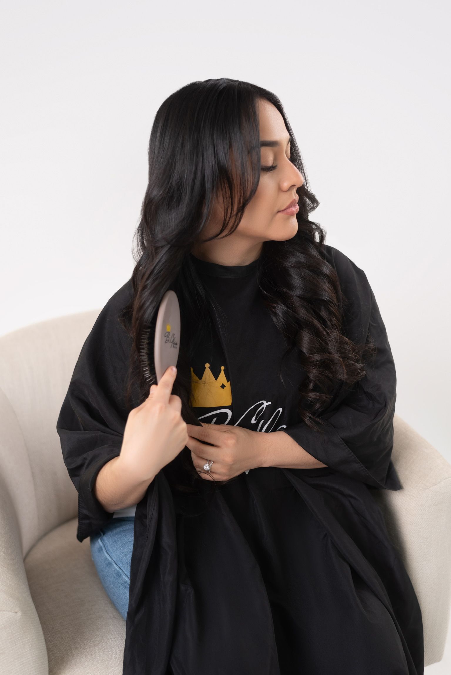 a lady brushing her long black hair