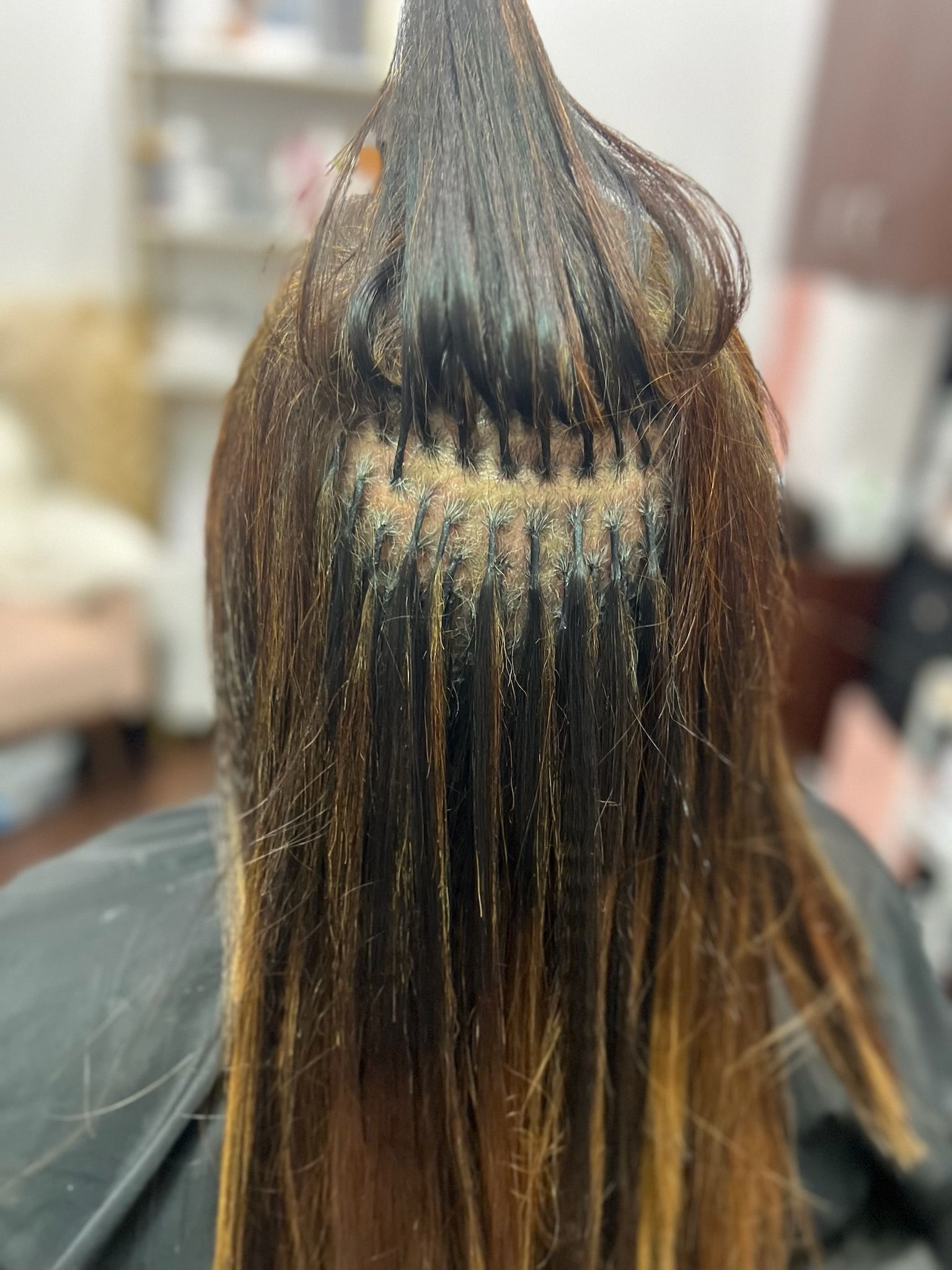 brown ombre extensions added to a lady in a salon