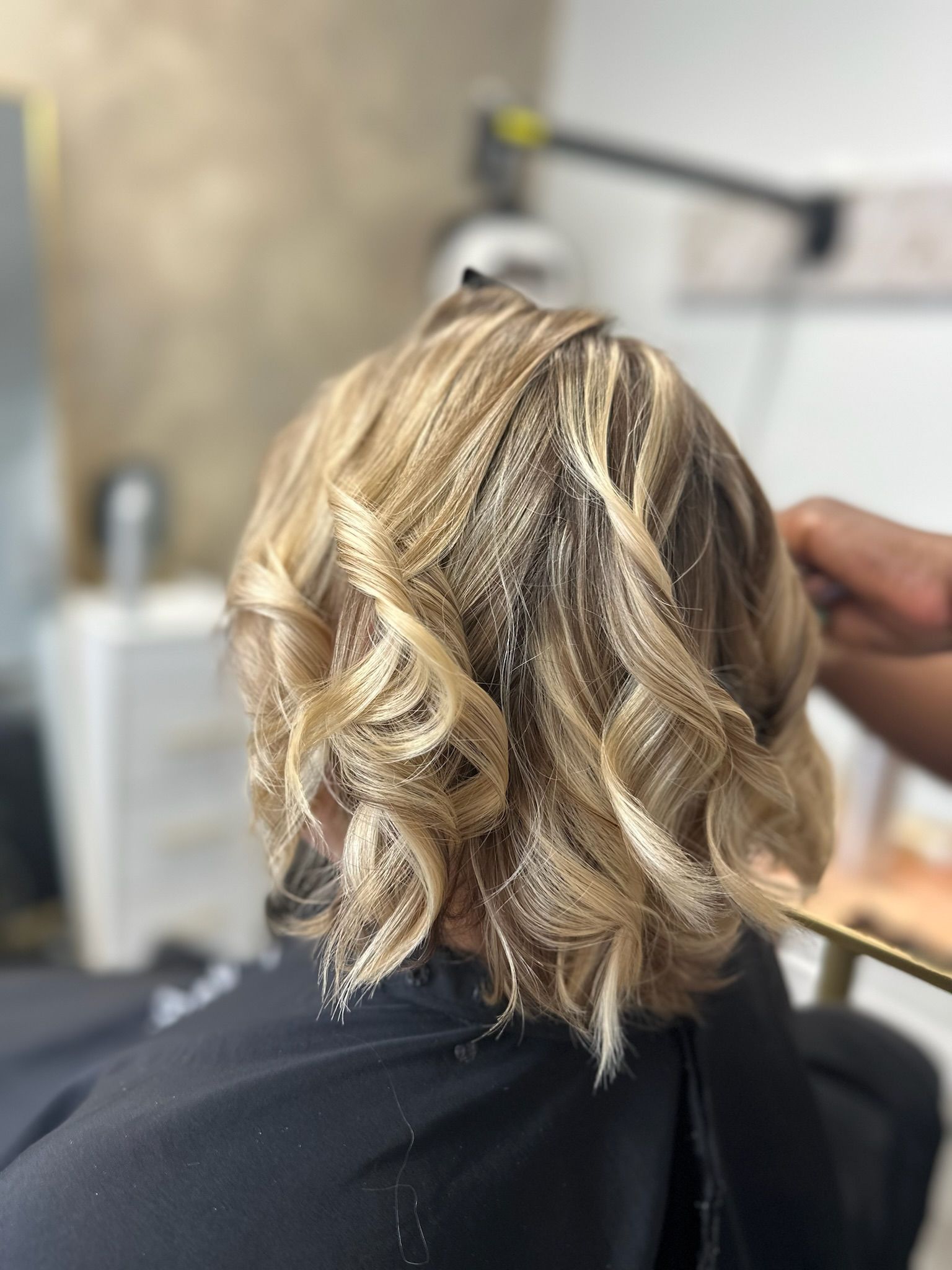 a lady with short brown hair with blond highlights