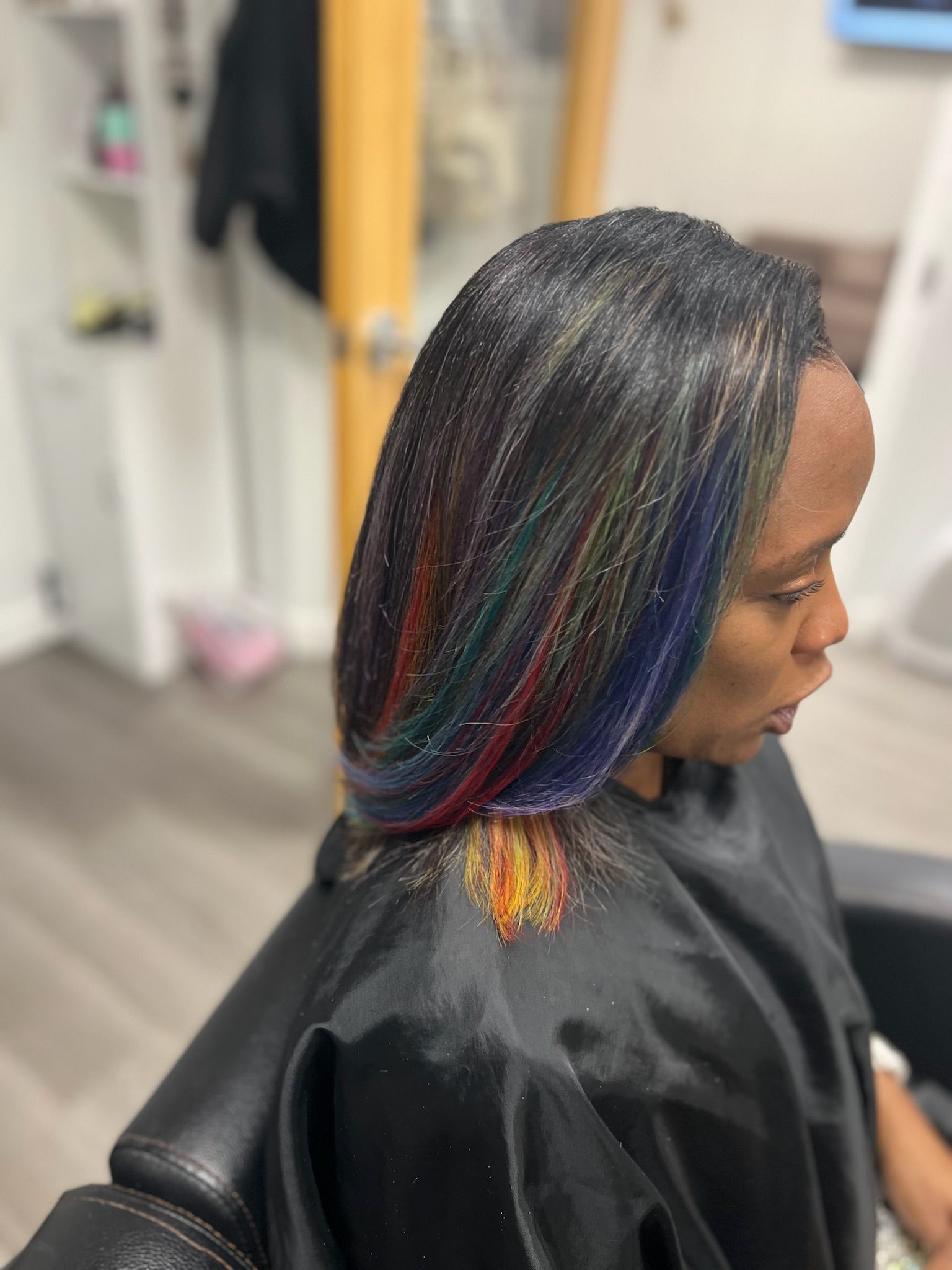 a black haired lady with blue streaks in her hair