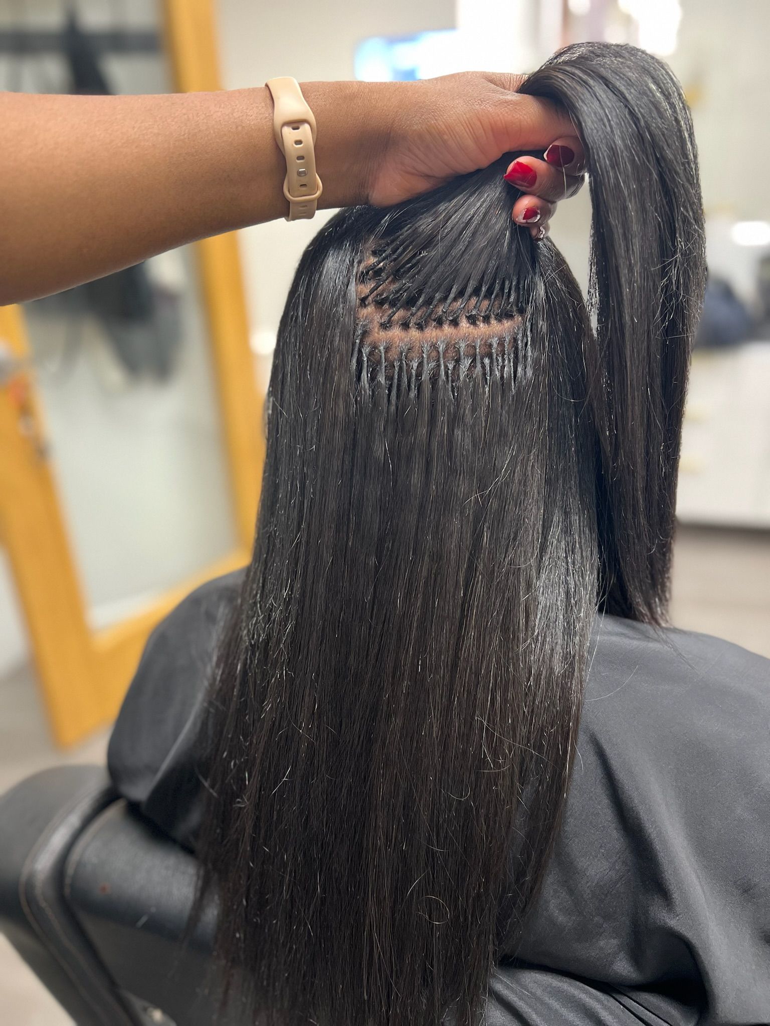 an image of a person getting black k tips in a hair salon.