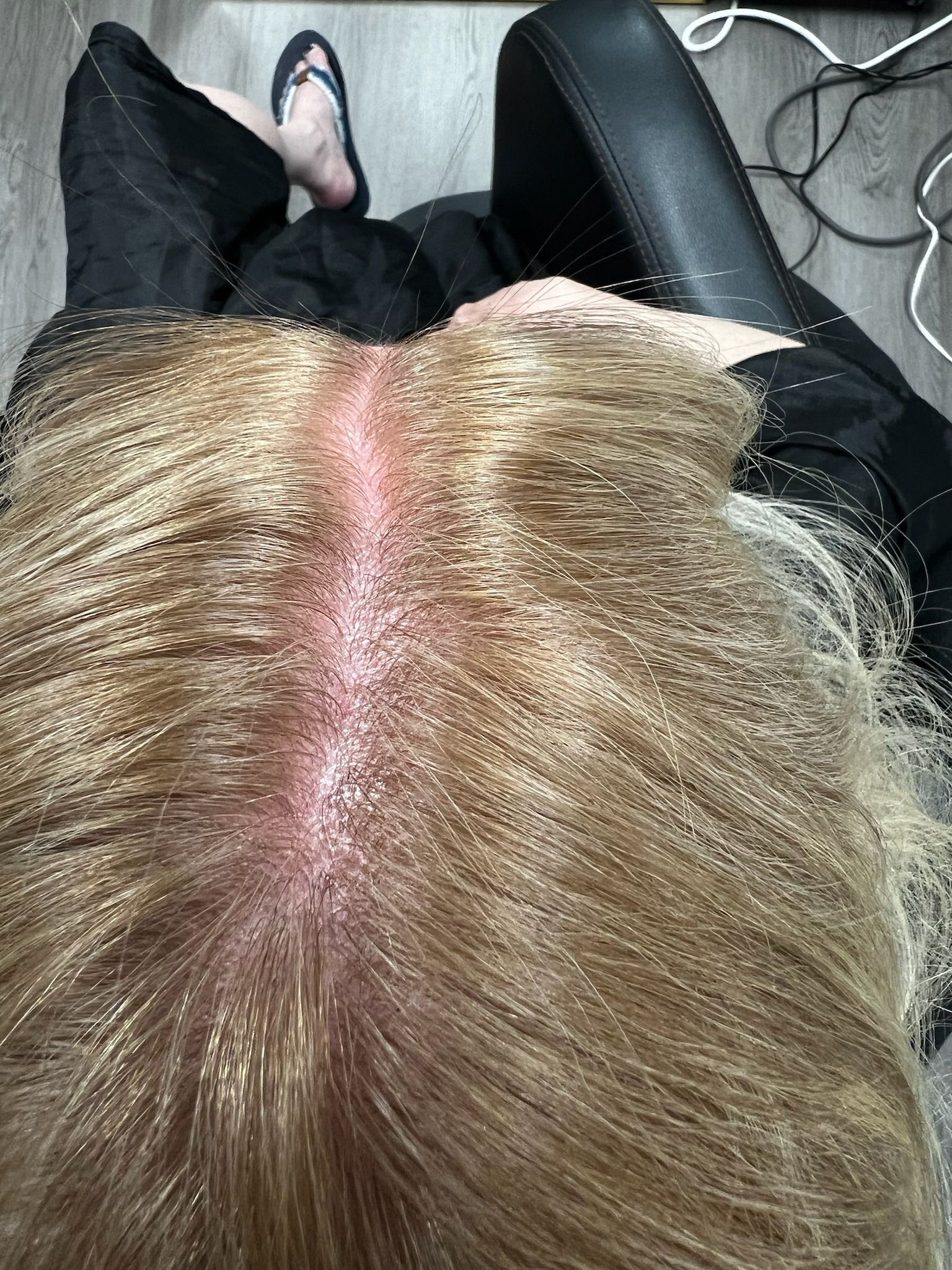 up close image of the roots of brown blond hair that have been colored
