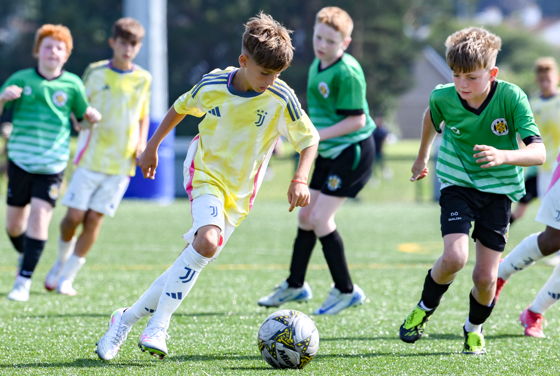 A group of young boys are playing soccer on a field.