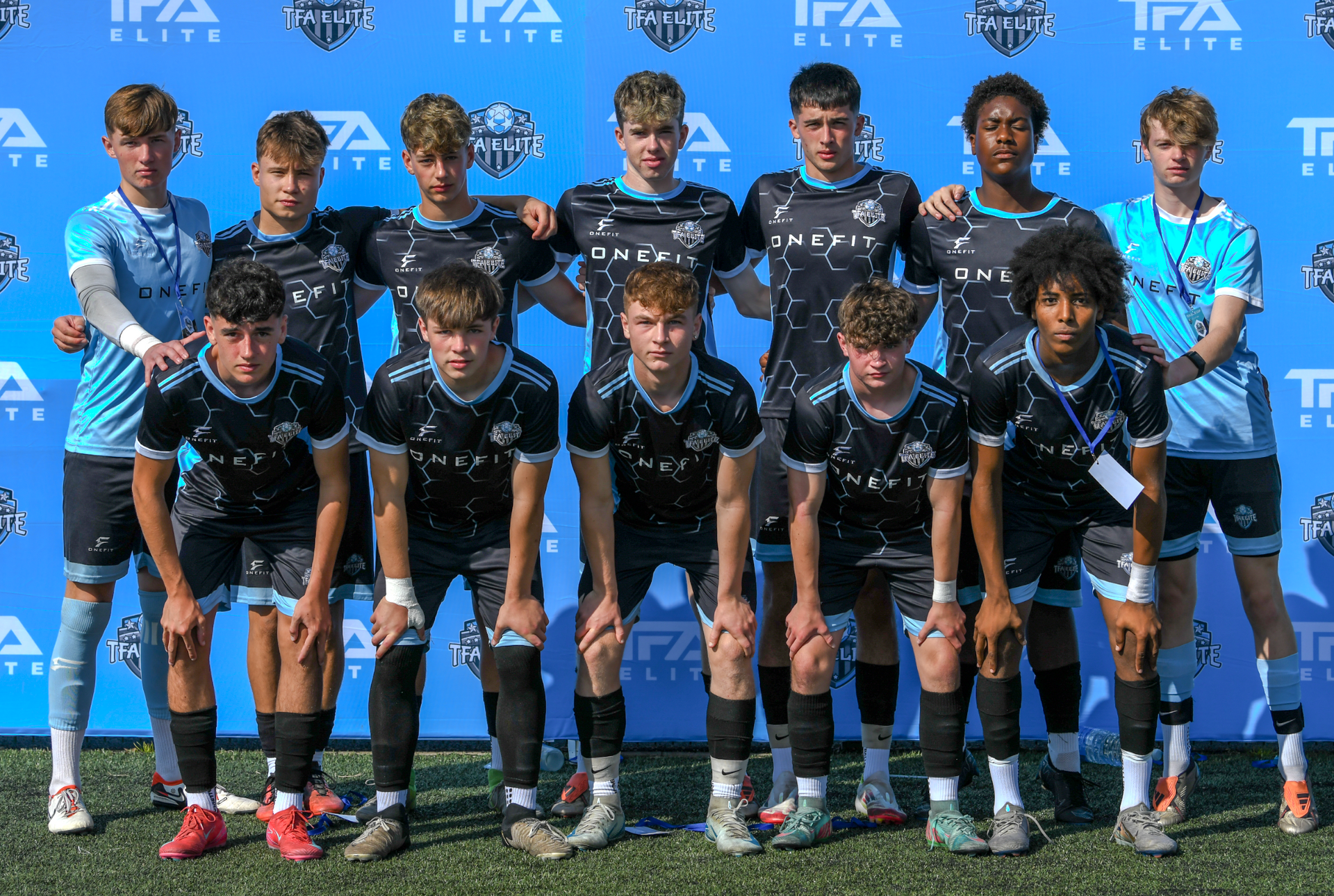 A group of young men are posing for a team photo.