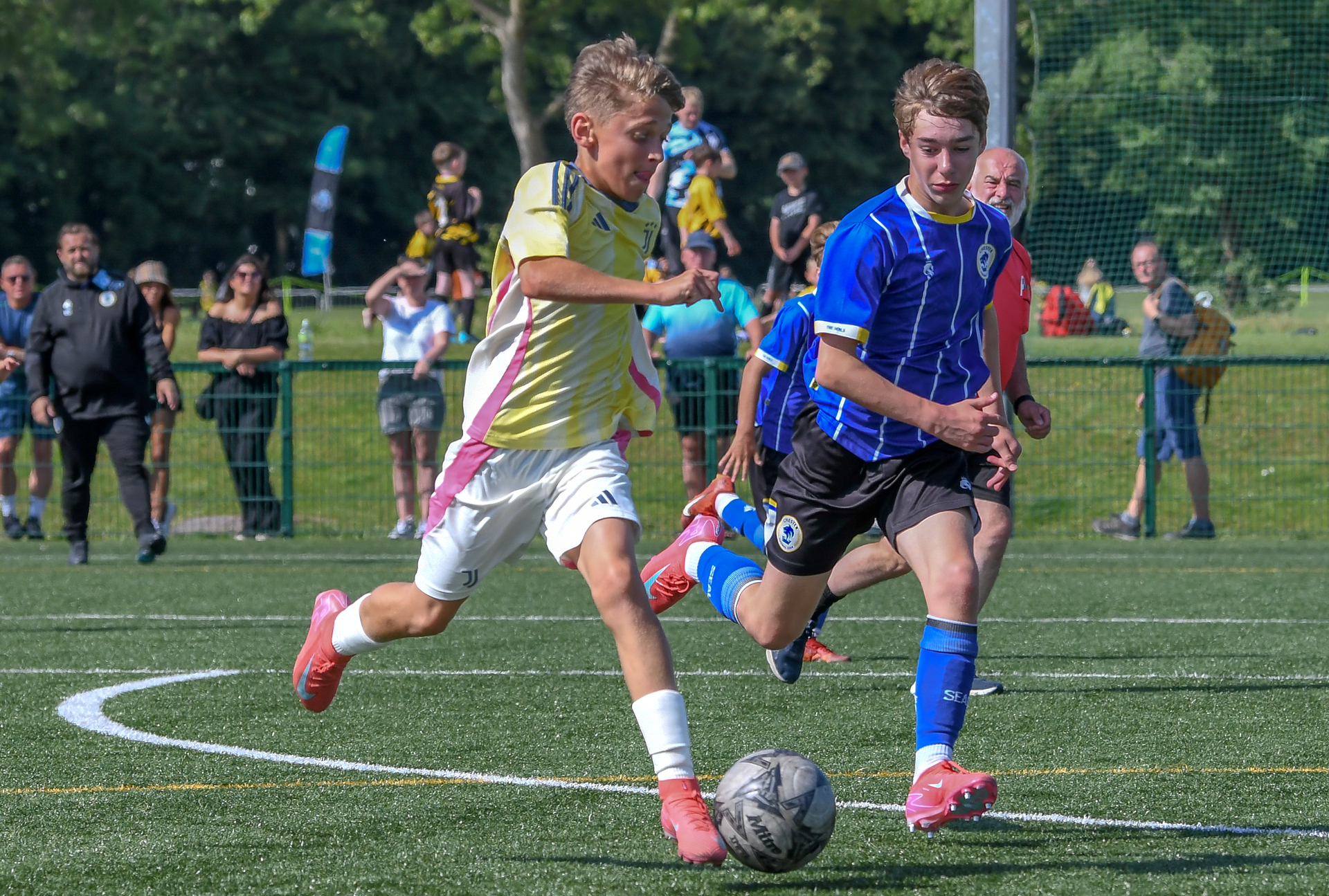 A group of young boys are playing soccer on a field.