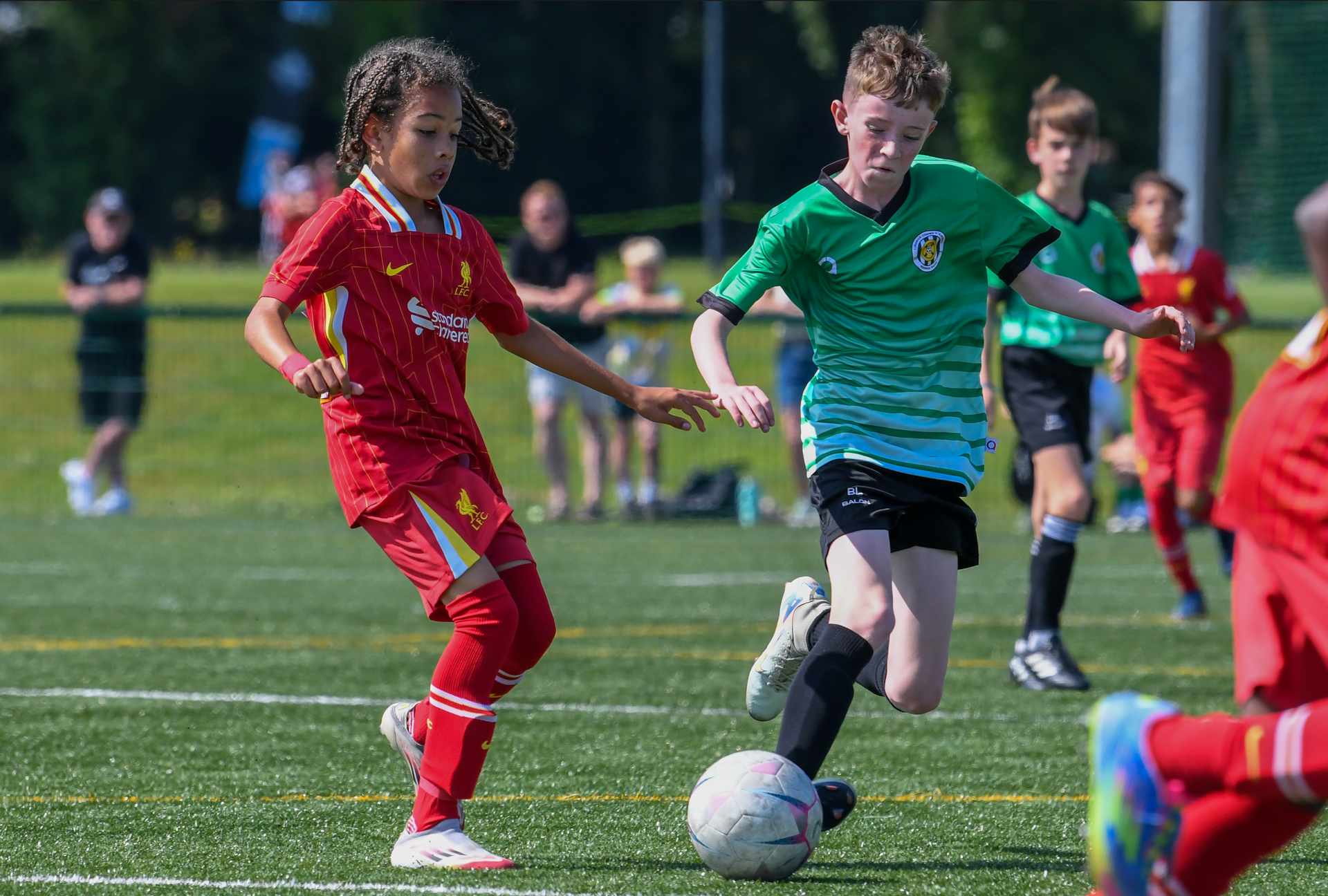 A group of young boys are playing soccer on a field.