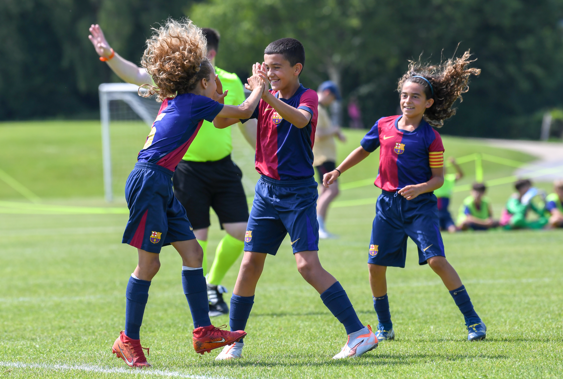 A group of young boys are playing soccer on a field.