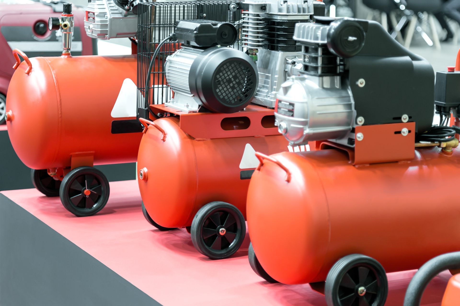 A row of orange air compressors.