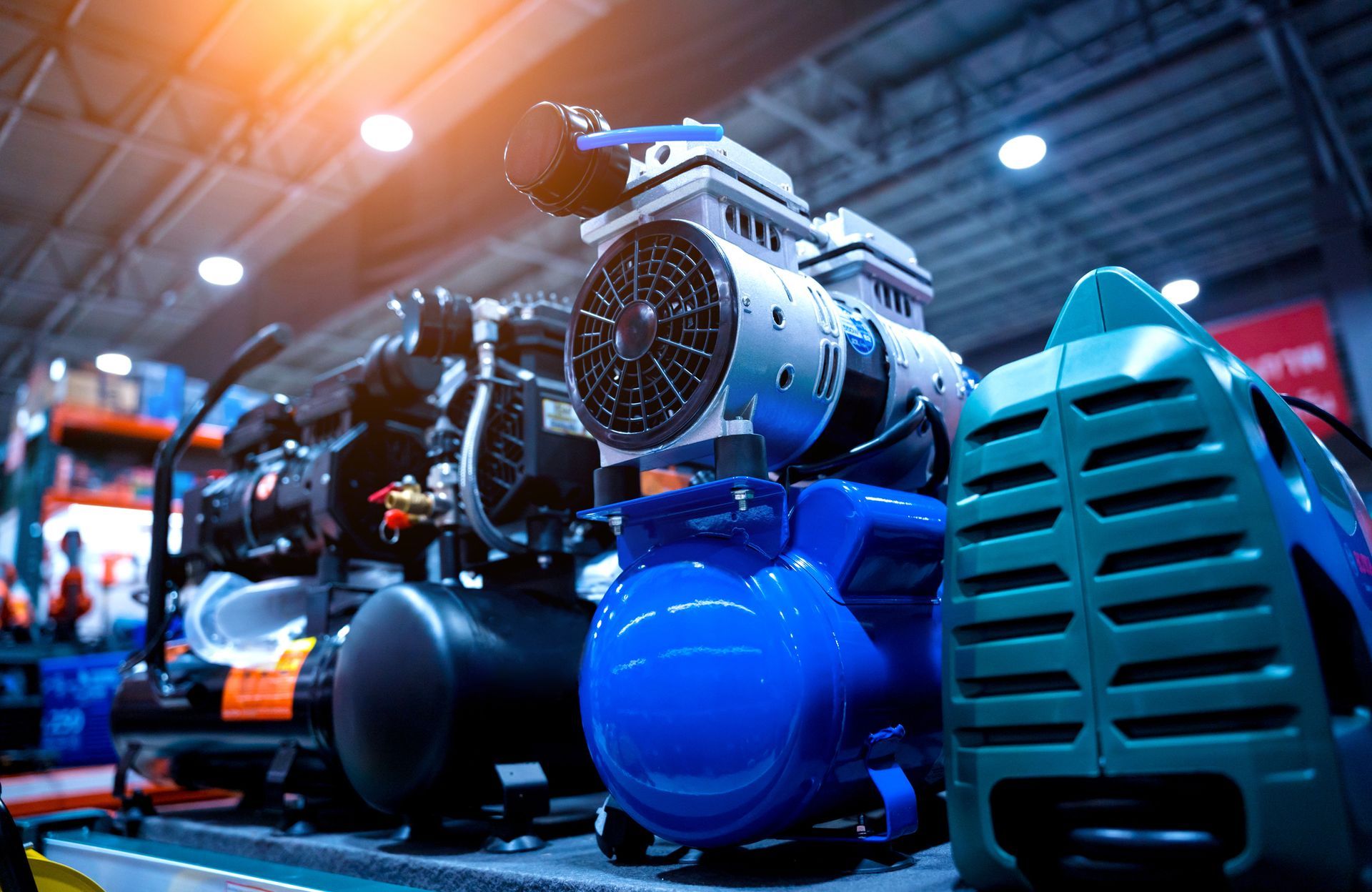 Air compressors lined up in a warehouse, showcasing various models from air compressor suppliers.