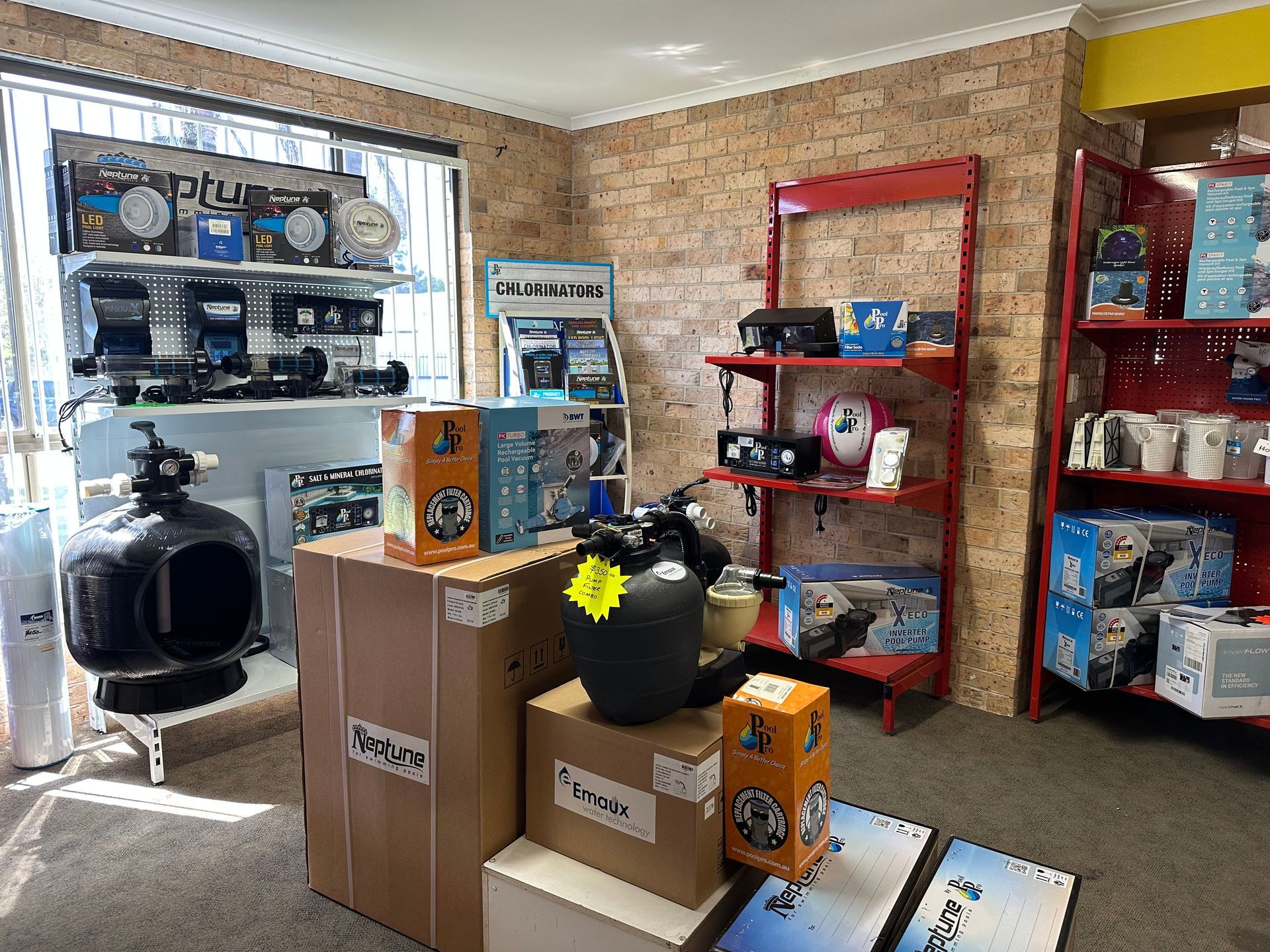 Interior of a pool supply store with shelves displaying pool equipment, including filters, pumps, and accessories. — Manning Pools, Rubber & Foam In Taree, NSW