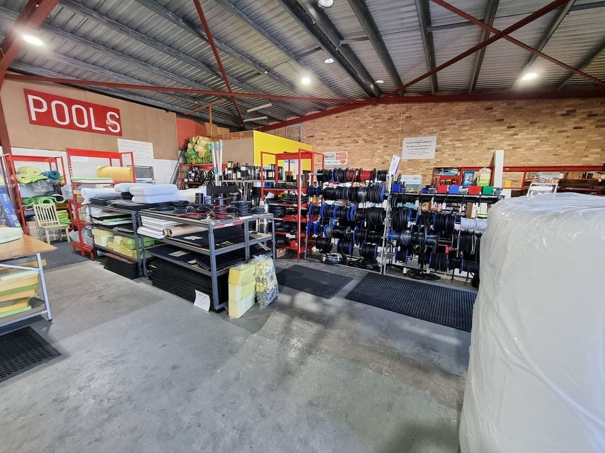 A Large Warehouse Filled With Lots Of Pool Equipment — Manning Pools, Rubber & Foam In Taree, NSW