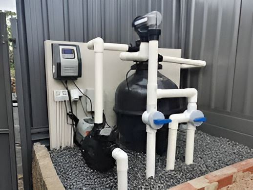 A Swimming Pool Filter Is Sitting On Top Of A Pile Of Gravel — Manning Pools, Rubber & Foam In Taree, NSW