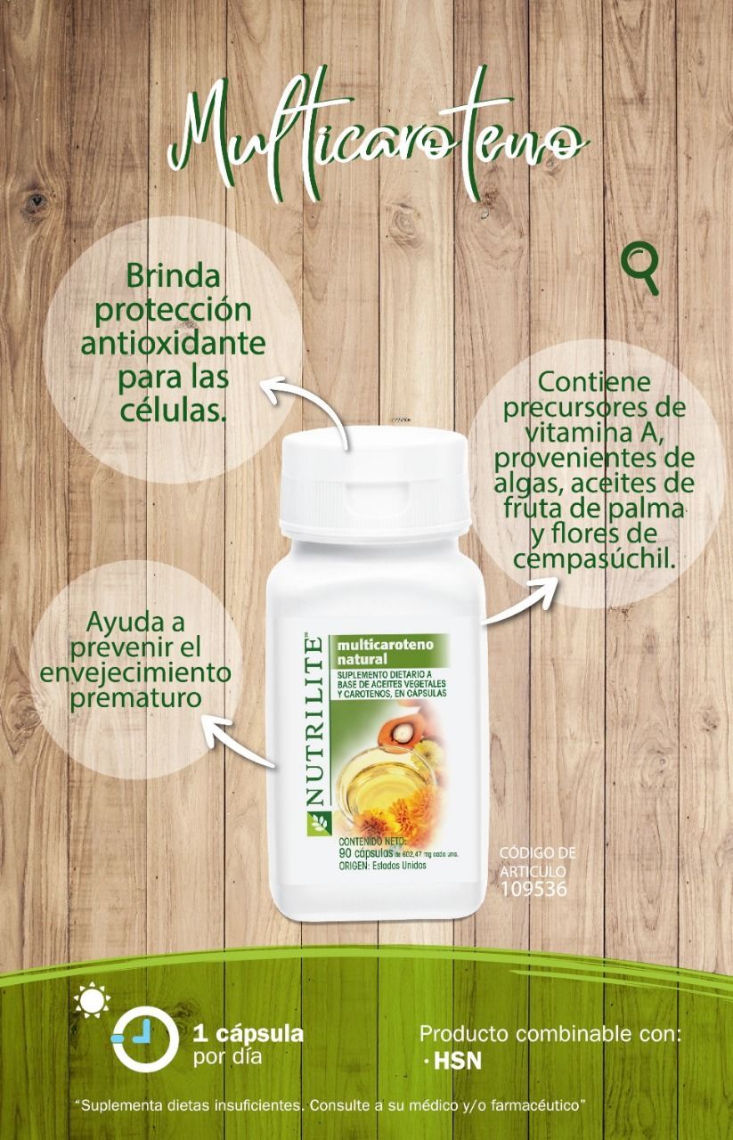 Una botella de multicaroteno nutrilite está sobre una mesa de madera.