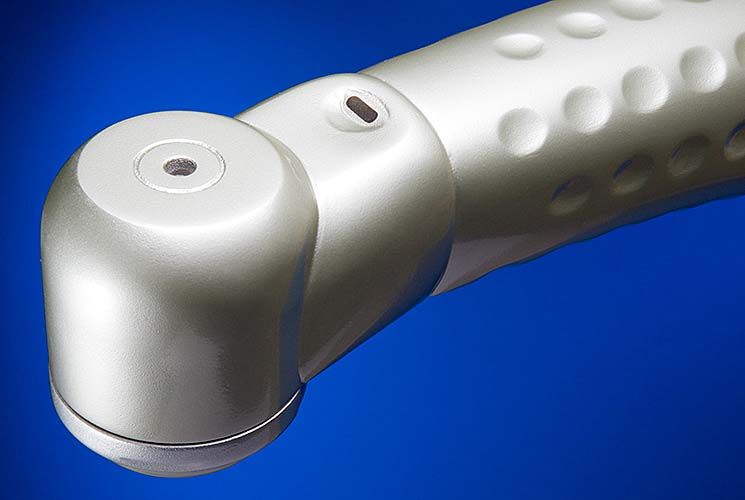 A close up of a silver object on a blue background