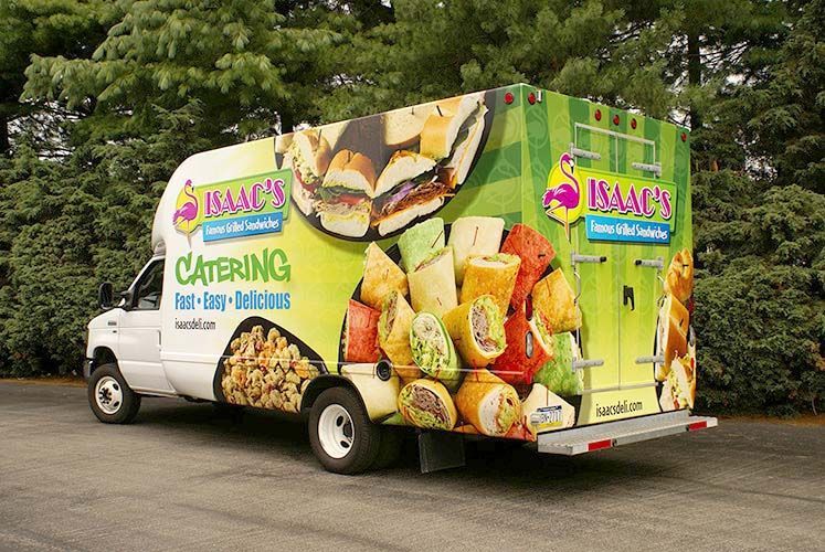 A catering truck is parked in a parking lot.
