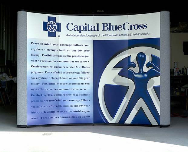 A blue and white sign that says capital bluecross