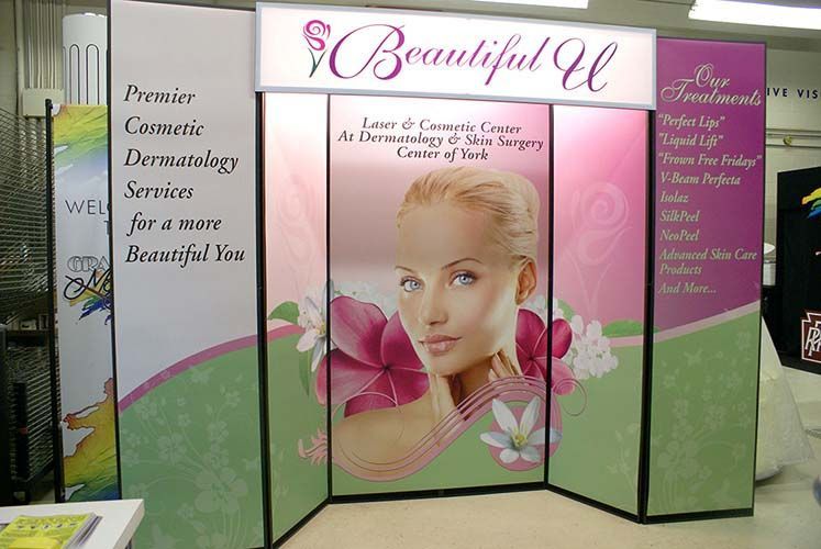 A display for a beauty salon with a woman 's face on it
