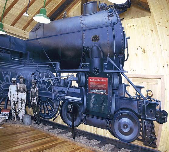 A painting of a train on a wooden wall