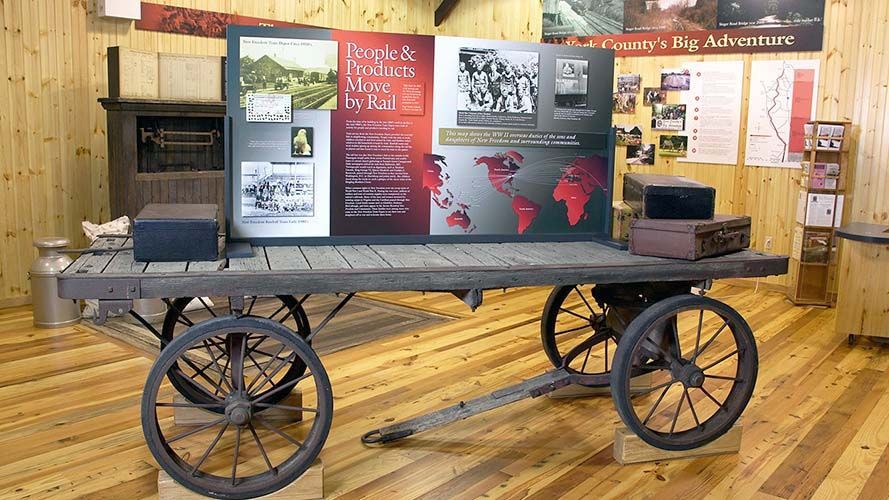 A wooden cart with a sign that says ' jesus 's house ' on it