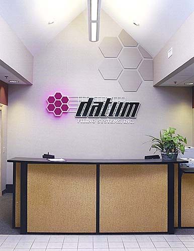 A titanium sign hangs above a reception desk